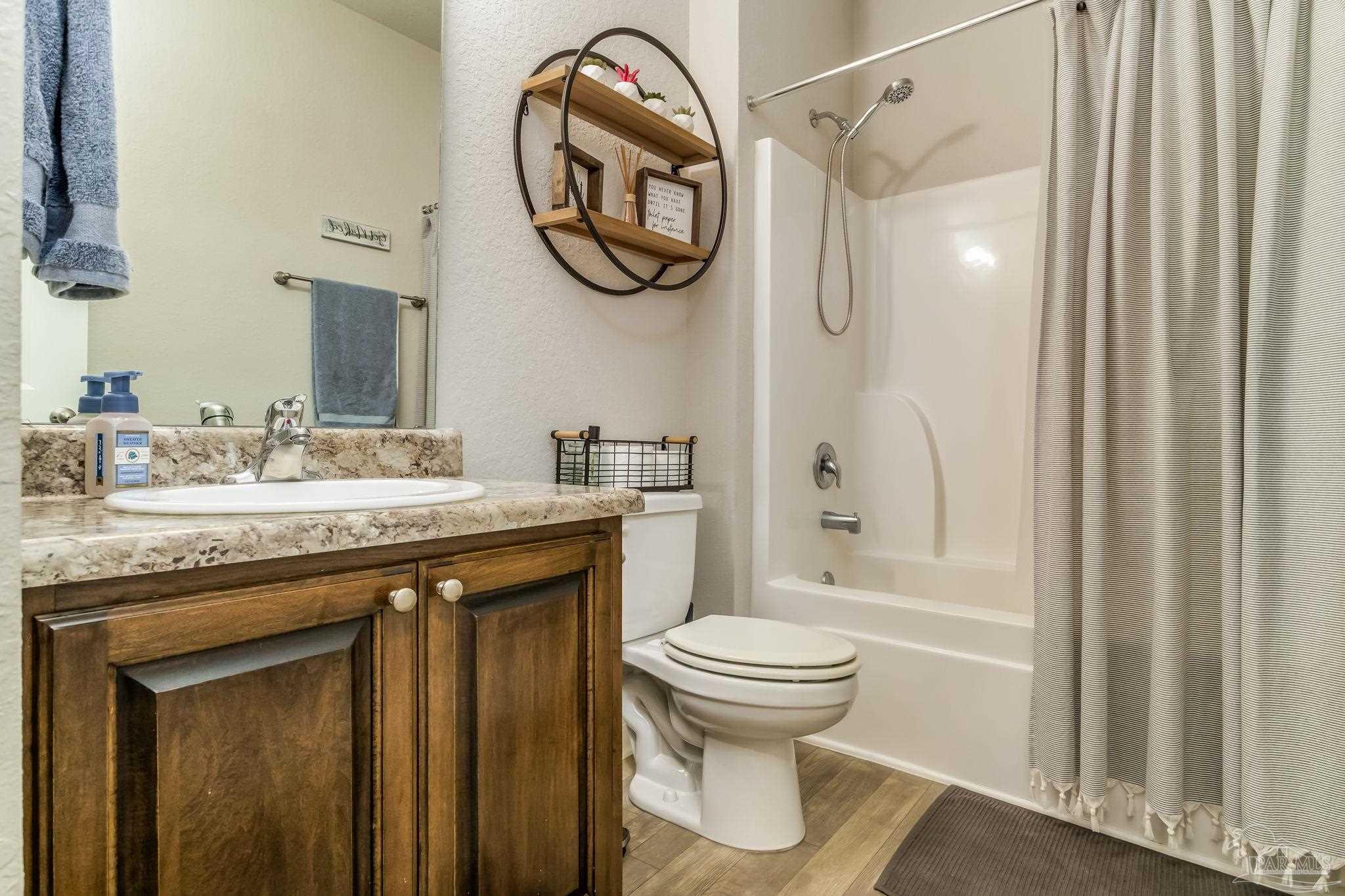 5185 Parkside Drive Pace, FL 32571 - Photo 42 of 43 a bathroom with a granite countertop sink toilet and shower