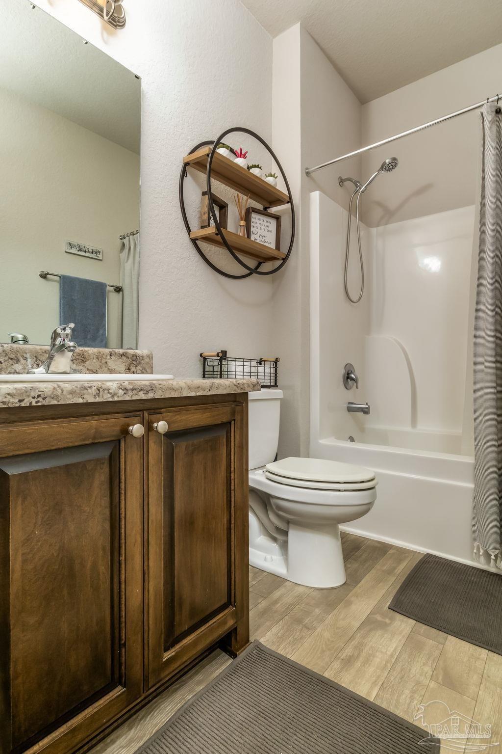 5185 Parkside Drive Pace, FL 32571 - Photo 43 of 43 a bathroom with a sink a toilet and a mirror