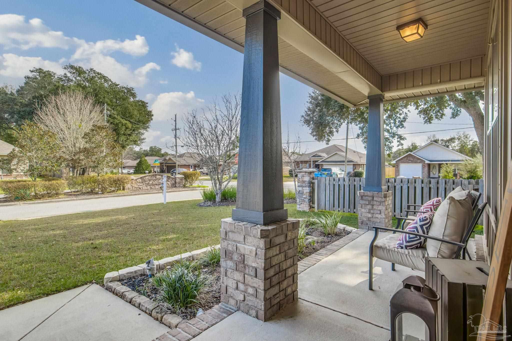 5185 Parkside Drive Pace, FL 32571 - Photo 6 of 43 a view of a patio with table and chairs potted plants with floor to ceiling window and yard