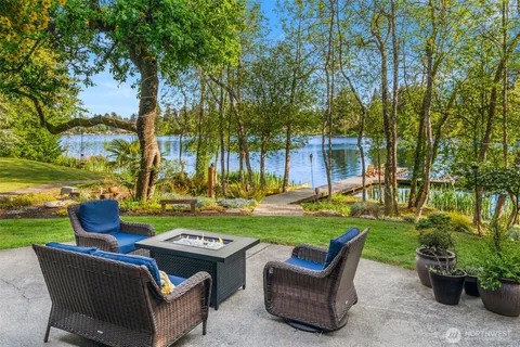 a view of patio with a table chairs and a fire pit
