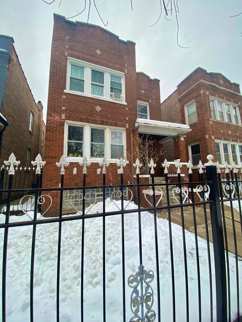 5225 West Deming Place, Unit 2 Chicago, IL 60639 - Photo 28 of 29 a view of a brick house with many windows