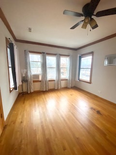 5225 West Deming Place, Unit 2 Chicago, IL 60639 - Photo 4 of 29 a view of empty room with wooden floor and fan