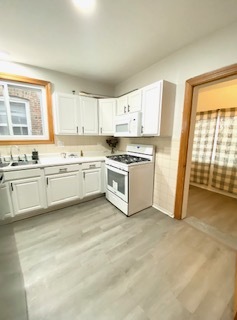 5225 West Deming Place, Unit 2 Chicago, IL 60639 - Photo 9 of 29 a kitchen with stainless steel appliances granite countertop a stove a sink and a microwave