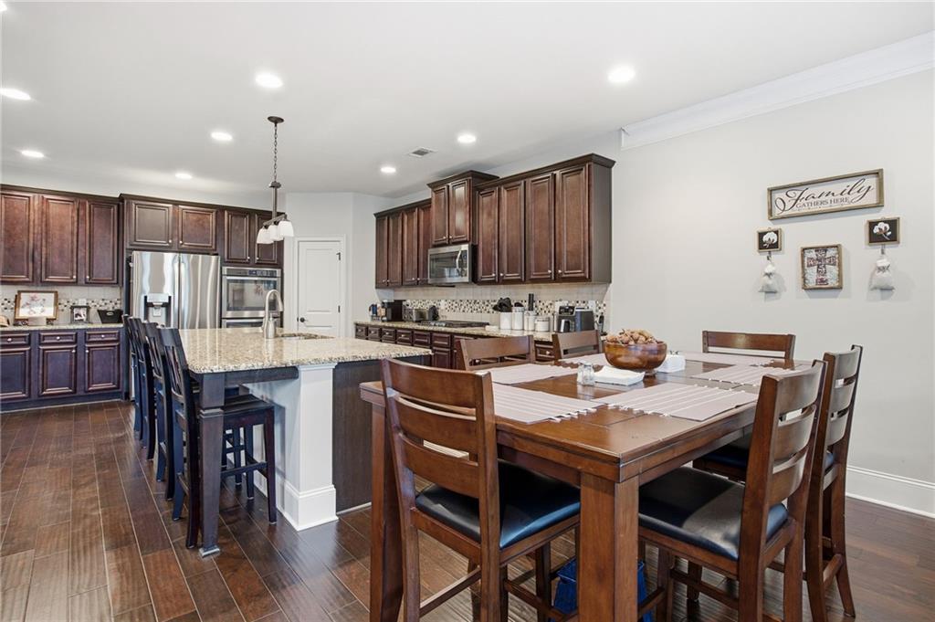 79 Gray Trail Acworth, GA 30101 - Photo 12 of 40 a kitchen with a dining table chairs and refrigerator