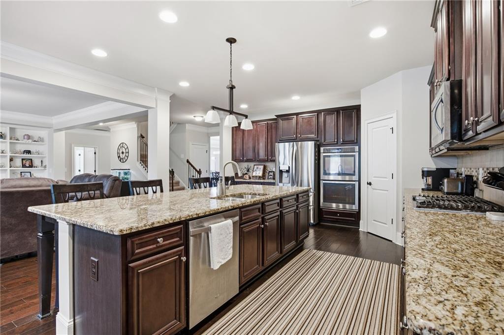 79 Gray Trail Acworth, GA 30101 - Photo 13 of 40 a kitchen with stainless steel appliances granite countertop a sink a stove and a refrigerator