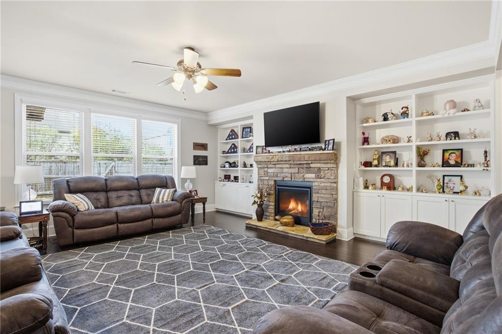 79 Gray Trail Acworth, GA 30101 - Photo 19 of 40 a living room with furniture a flat screen tv and a fireplace