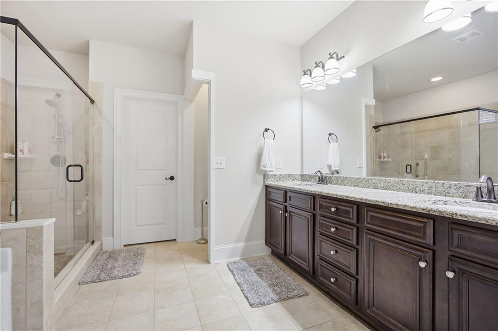 79 Gray Trail Acworth, GA 30101 - Photo 25 of 40 a bathroom with a double vanity sink mirror and shower