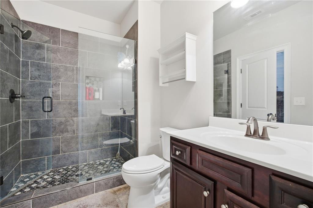 79 Gray Trail Acworth, GA 30101 - Photo 30 of 40 a bathroom with a sink a toilet and shower