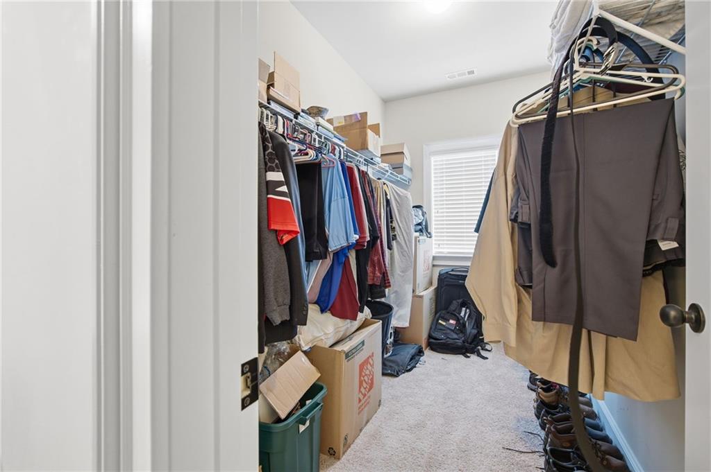 79 Gray Trail Acworth, GA 30101 - Photo 31 of 40 a view of walk in closet with clothes and shoes