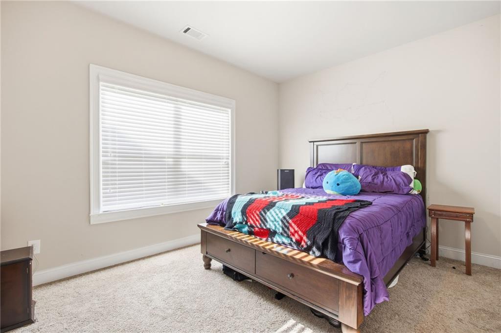 79 Gray Trail Acworth, GA 30101 - Photo 35 of 40 a bed sitting in a bedroom next to a window