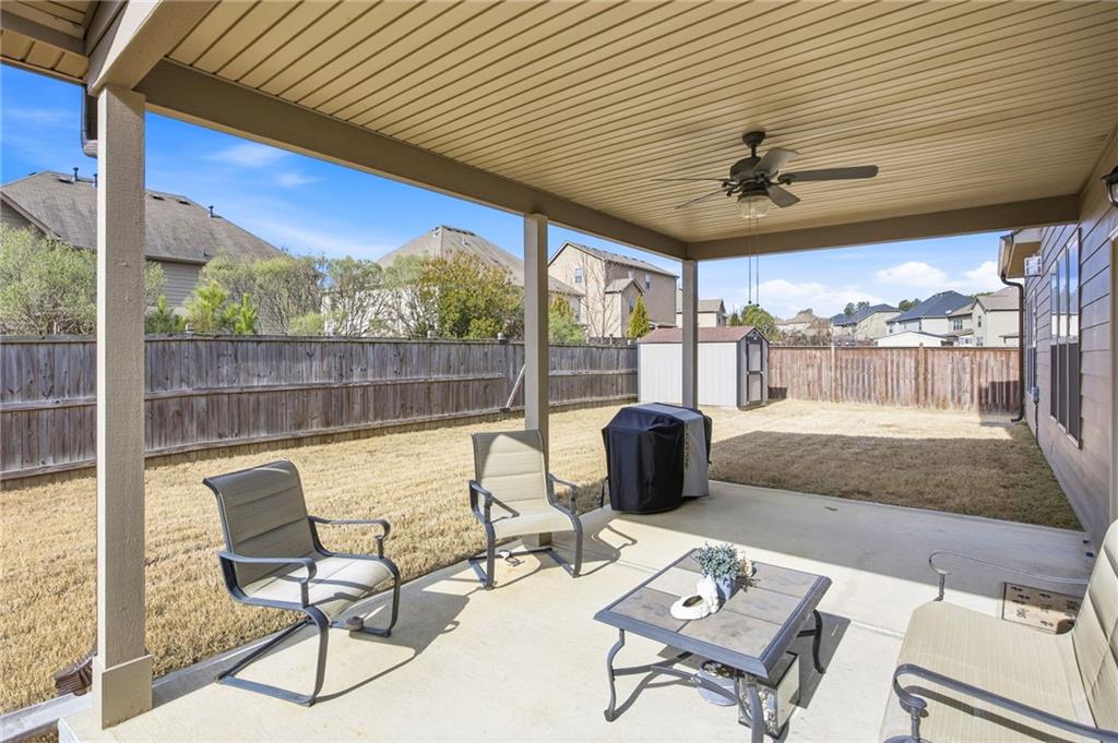 79 Gray Trail Acworth, GA 30101 - Photo 36 of 40 a view of a patio with a table chairs and flat screen tv