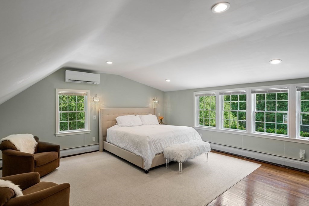 850 Boston Post Road Weston, MA 02493 - Photo 12 of 29 a bedroom with a bed and a couch with window