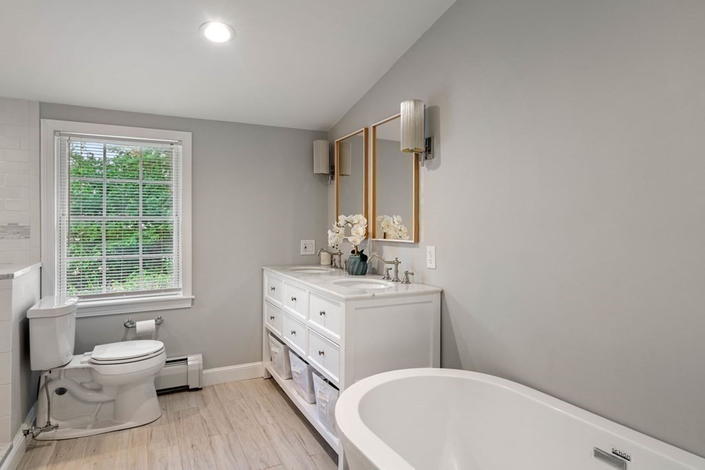 850 Boston Post Road Weston, MA 02493 - Photo 13 of 29 a bathroom with a double vanity sink a mirror and a toilet