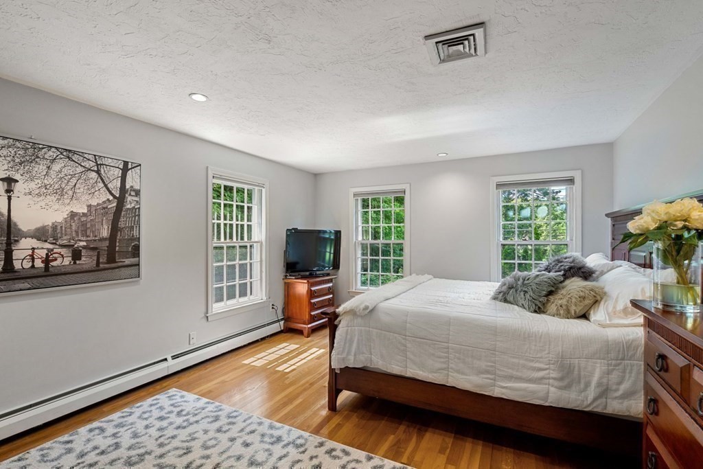 850 Boston Post Road Weston, MA 02493 - Photo 18 of 29 a bedroom with a bed wooden floor and window