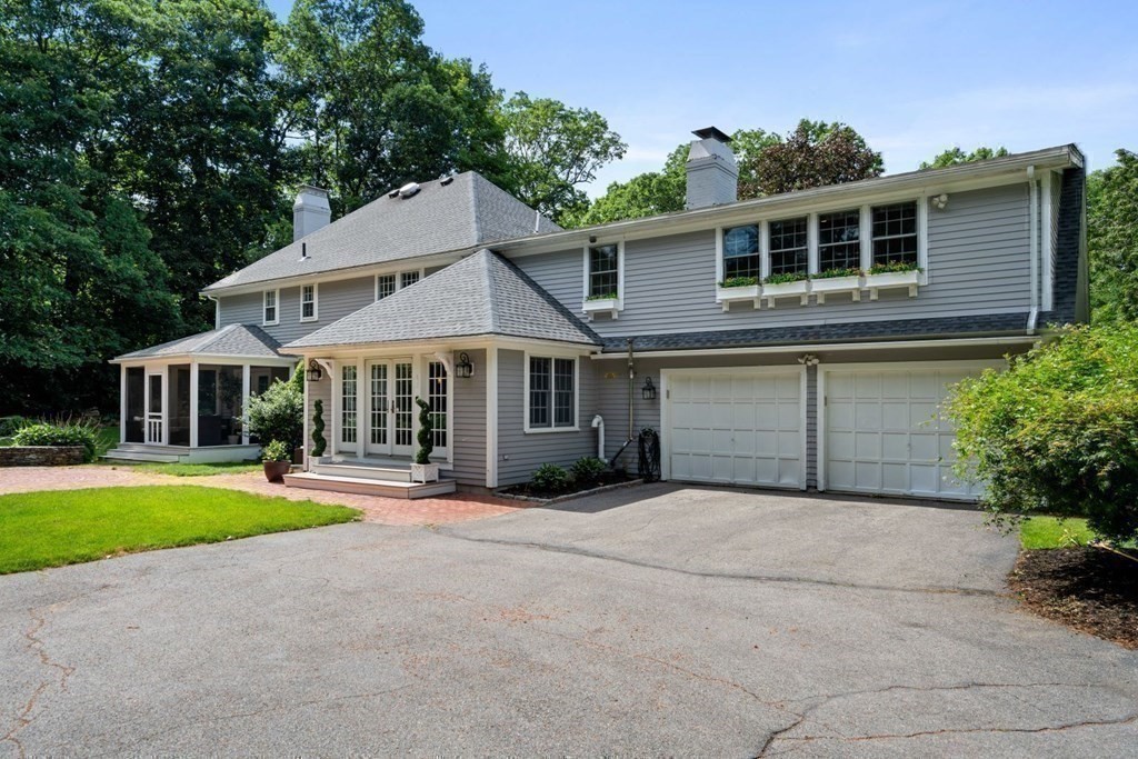 850 Boston Post Road Weston, MA 02493 - Photo 26 of 29 a front view of a house with a yard and garage
