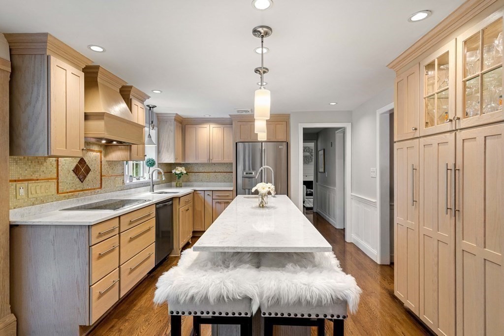 850 Boston Post Road Weston, MA 02493 - Photo 9 of 29 a large kitchen with kitchen island granite countertop a stove a sink a refrigerator and white cabinets with wooden floor