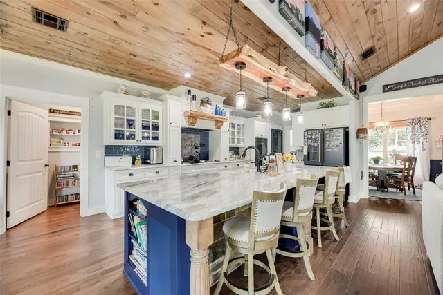 a dining room with furniture and wooden floor