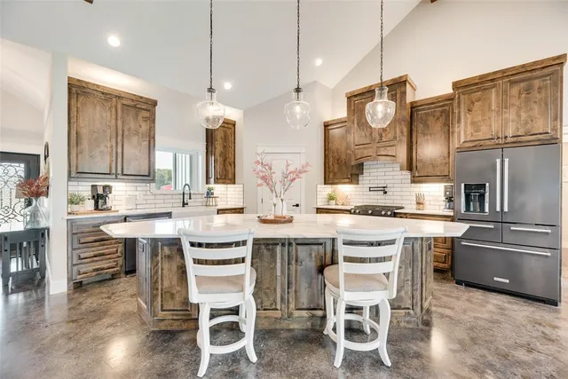 a kitchen with stainless steel appliances granite countertop a stove and a refrigerator