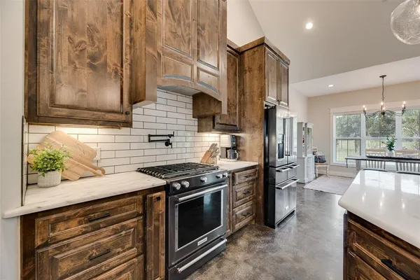 a kitchen with a sink stove and cabinets
