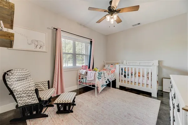 a living room with furniture ceiling fan and a wooden floor