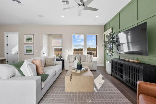 a living room with furniture fireplace and a window