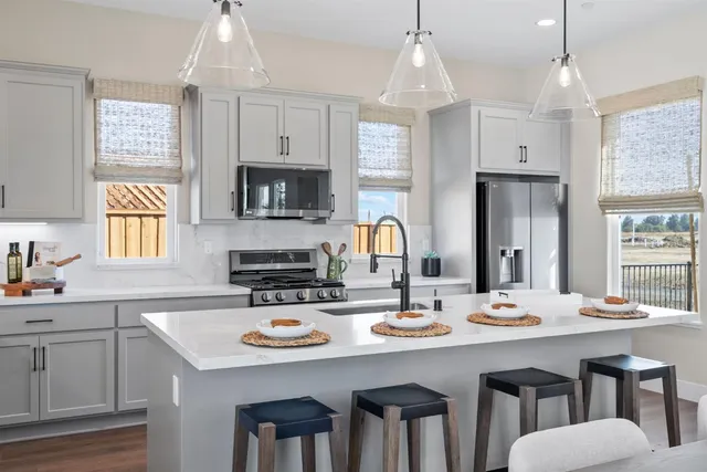 a kitchen with a sink stove and microwave
