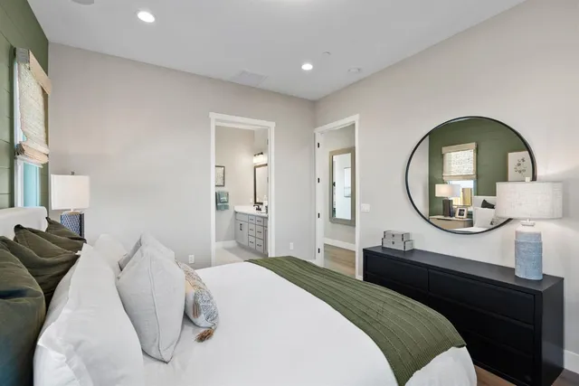 a bedroom with a bed and a mirror