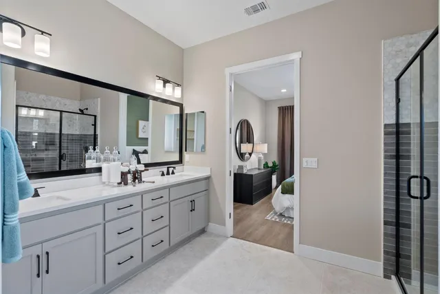 a bathroom with a double vanity sink and mirror