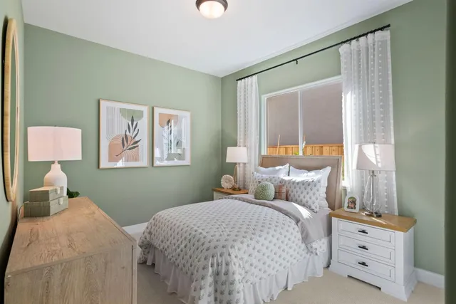 a bedroom with a bed and lamp