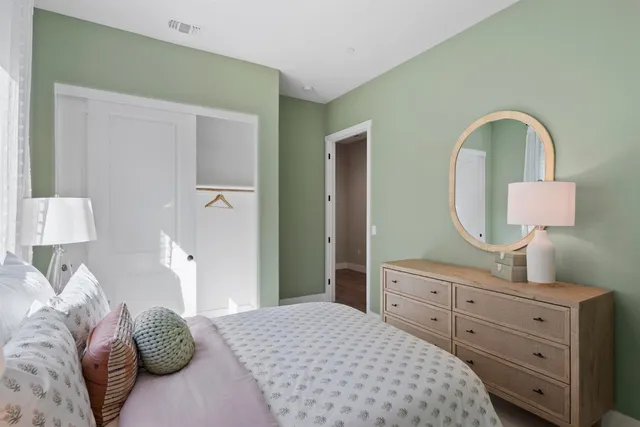 a bedroom with a bed and a dresser