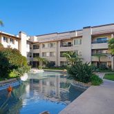 a view of a patio with table and chairs and potted plants