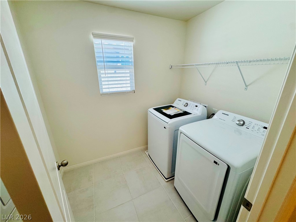 9249 Innot Avenue Las Vegas, NV 89148 - Photo 13 of 24 A dedicated laundry space, thoughtfully appointed with a washer and dryer for effortless household chores.