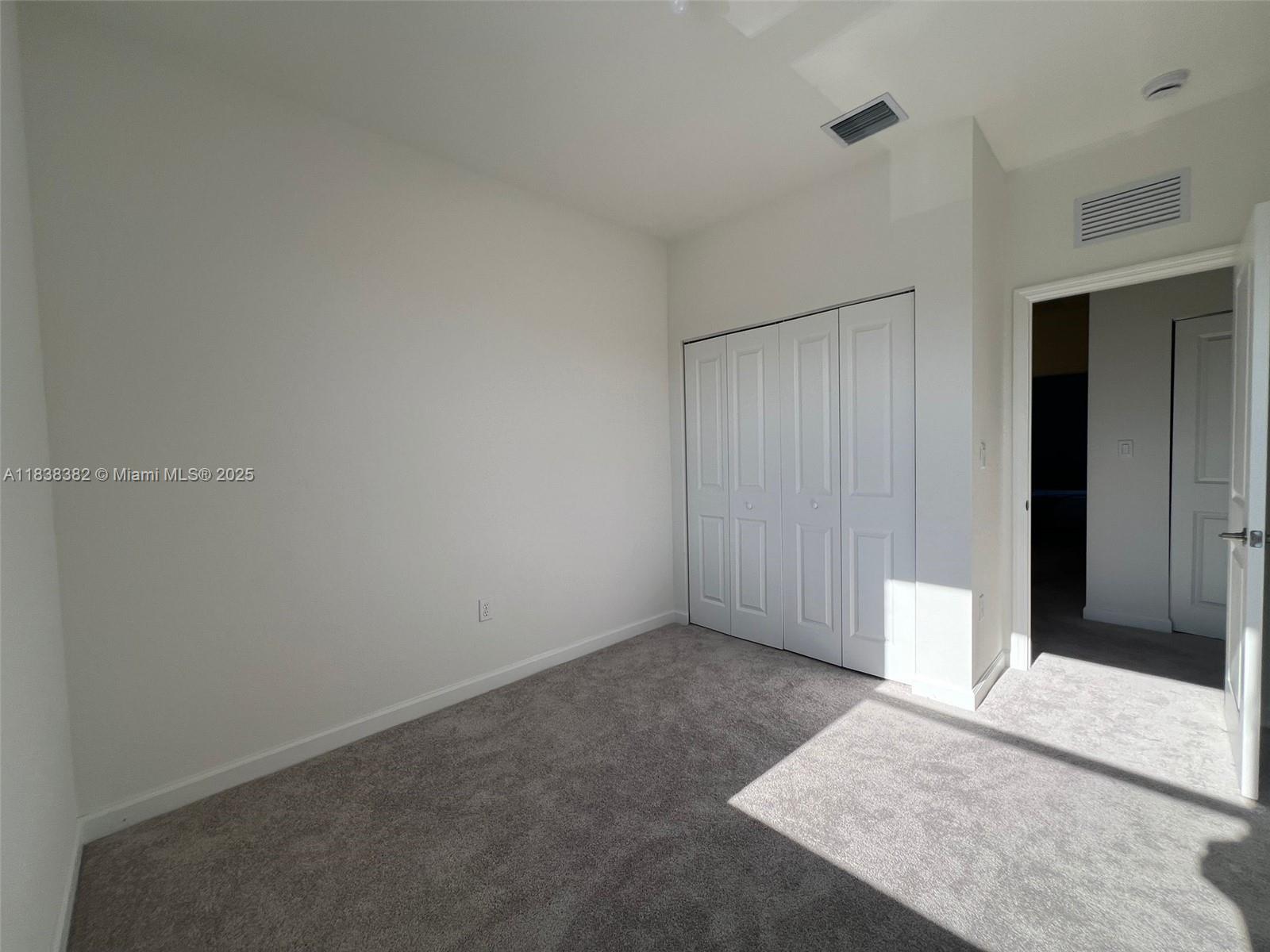 151 Southeast 11th Avenue, Unit 151 Florida City, FL 33034 - Photo 14 of 20 an empty room with windows