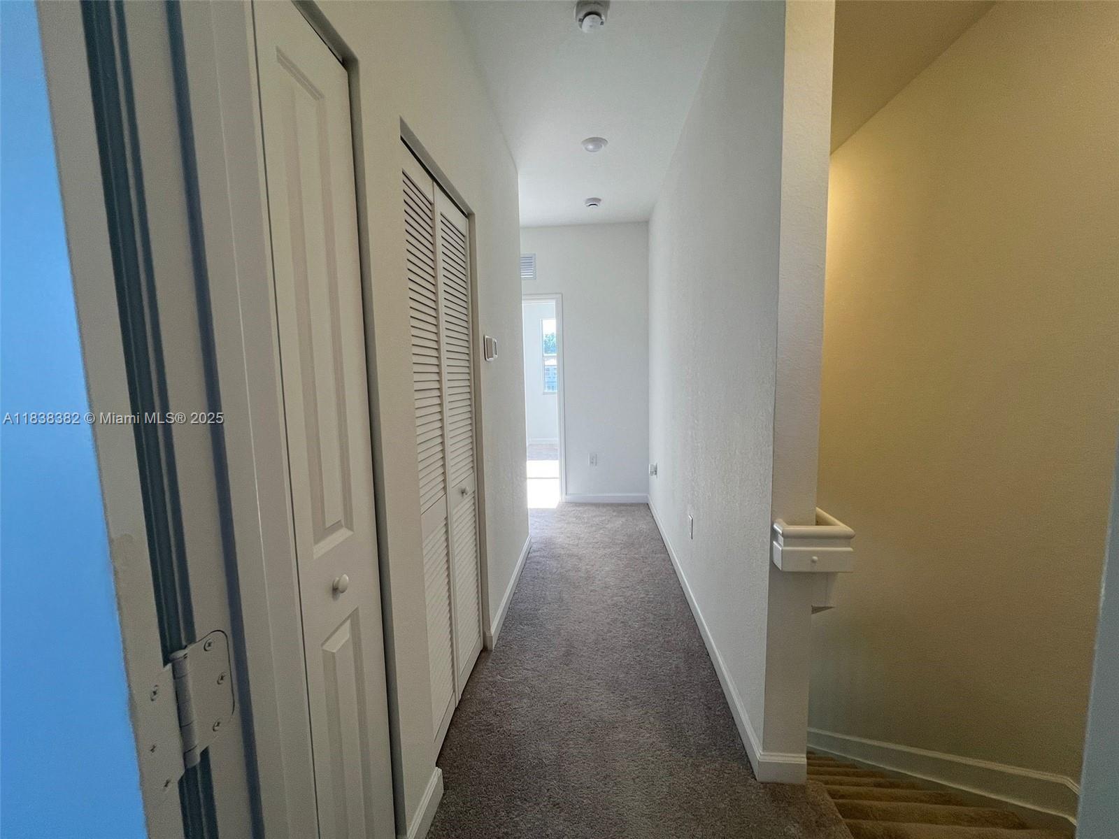 151 Southeast 11th Avenue, Unit 151 Florida City, FL 33034 - Photo 15 of 20 a view of a hallway with wooden floor