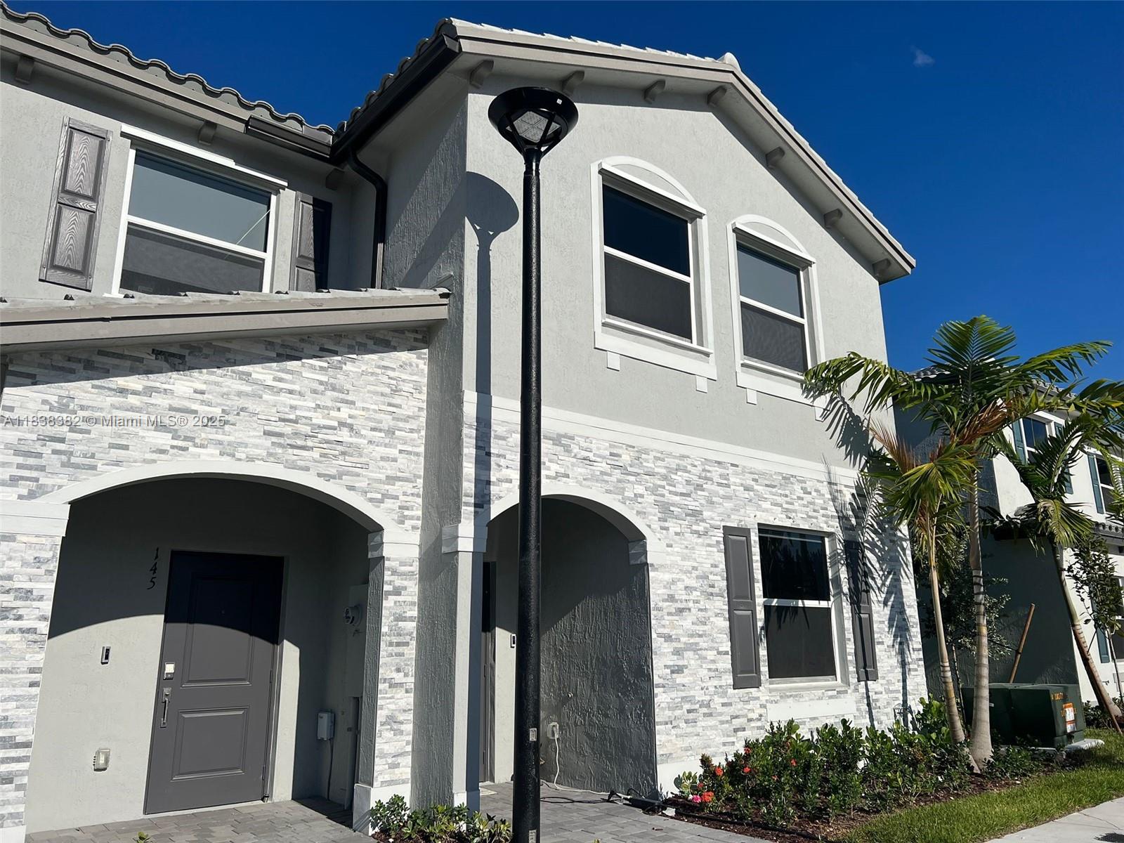 151 Southeast 11th Avenue, Unit 151 Florida City, FL 33034 - Photo 20 of 20 a front view of a house with a garage