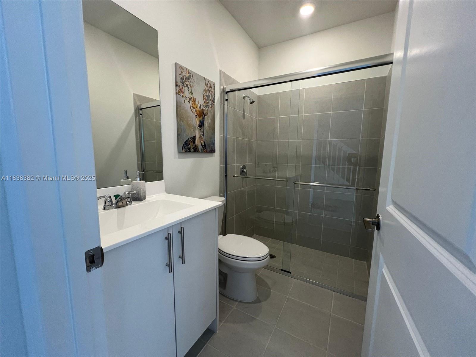 151 Southeast 11th Avenue, Unit 151 Florida City, FL 33034 - Photo 6 of 20 a bathroom with a sink toilet and shower