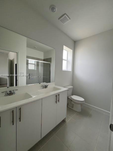 151 Southeast 11th Avenue, Unit 151 Florida City, FL 33034 - Photo 7 of 20 a bathroom with a sink and mirror with toilet