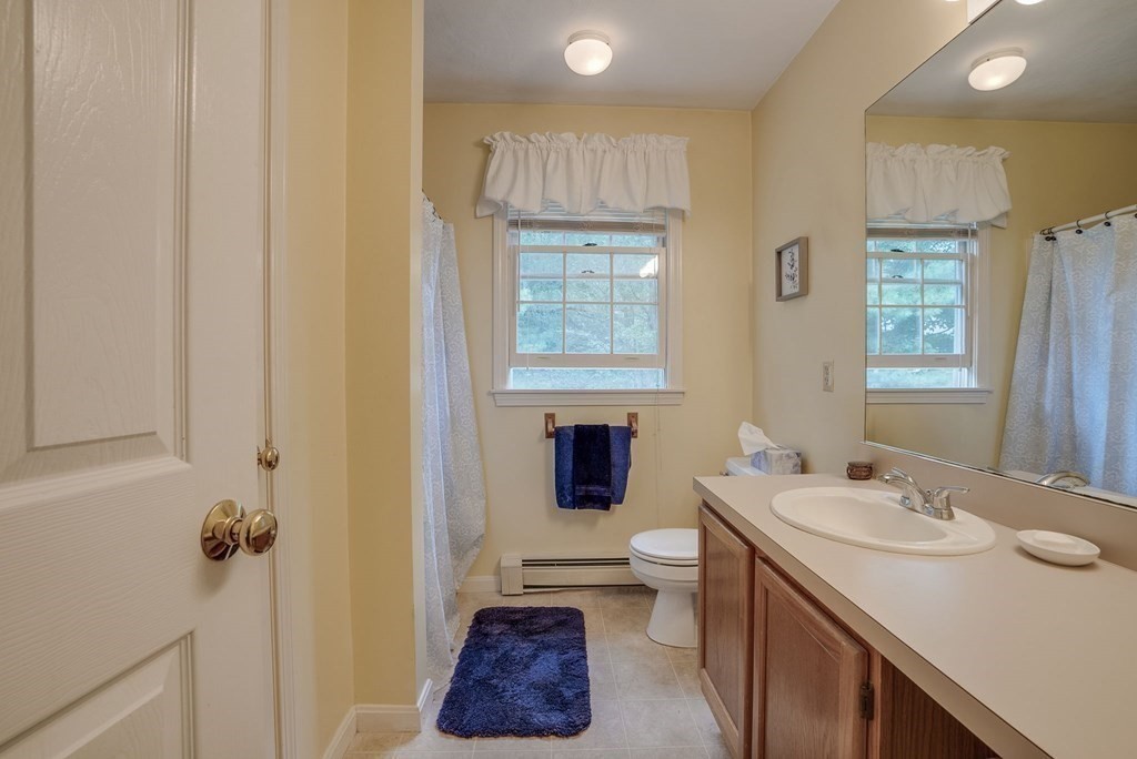 4 Carbone Circle Maynard, MA 01754 - Photo 19 of 38 a bathroom with a sink toilet and a mirror