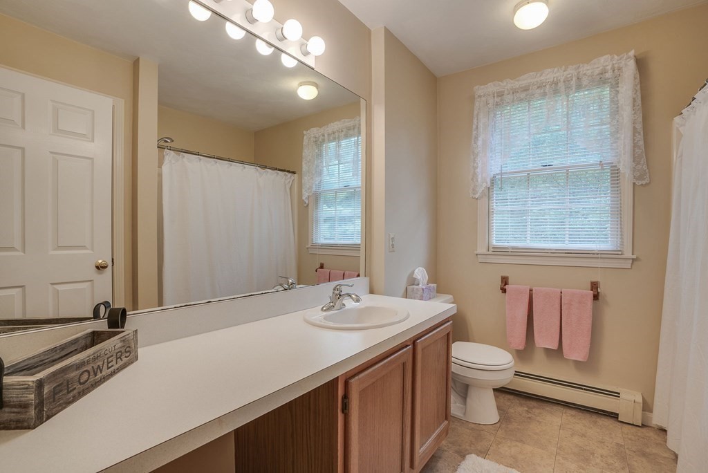 4 Carbone Circle Maynard, MA 01754 - Photo 24 of 38 a bathroom with a sink a toilet and a mirror