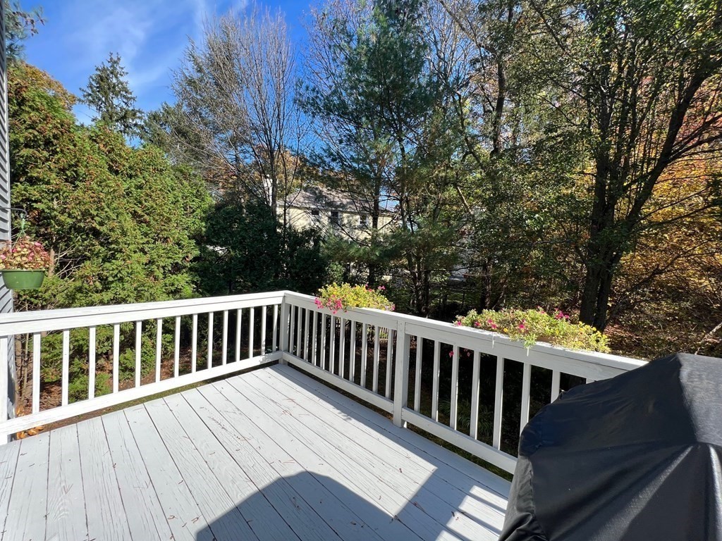 4 Carbone Circle Maynard, MA 01754 - Photo 26 of 38 a balcony with wooden floor and fence