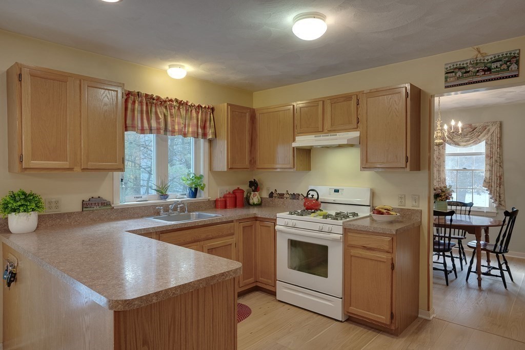 4 Carbone Circle Maynard, MA 01754 - Photo 5 of 38 a kitchen with a stove sink and cabinets