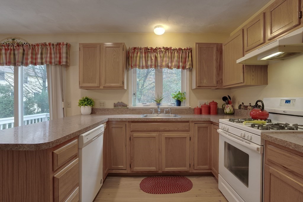 4 Carbone Circle Maynard, MA 01754 - Photo 6 of 38 a kitchen with a sink stove and cabinets