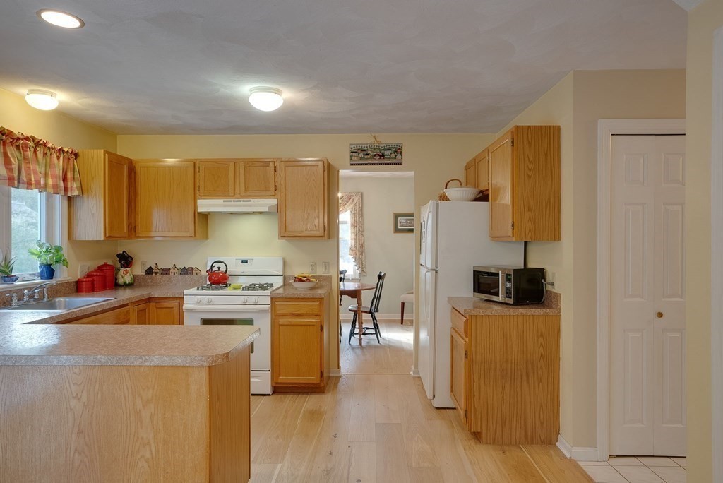 4 Carbone Circle Maynard, MA 01754 - Photo 7 of 38 a kitchen that has a lot of cabinets and wooden floor