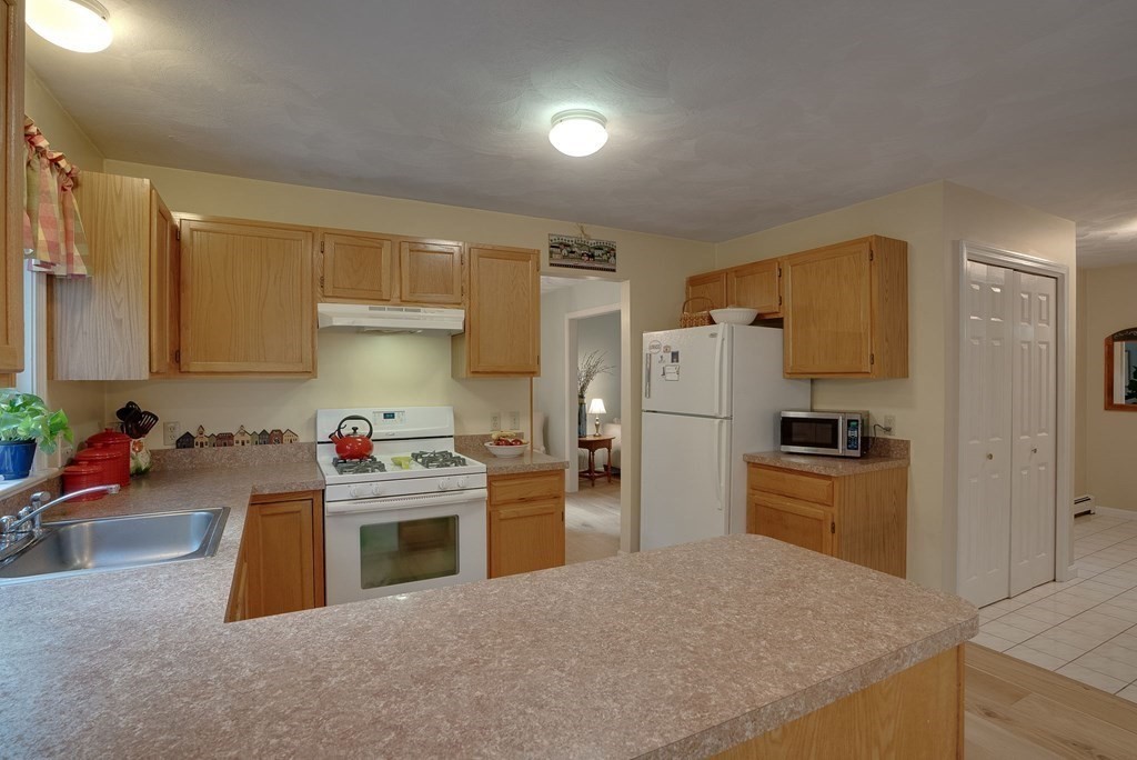 4 Carbone Circle Maynard, MA 01754 - Photo 8 of 38 a kitchen with a refrigerator and a sink