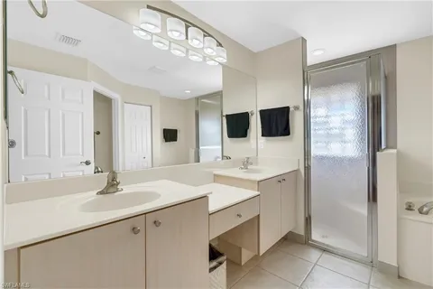 a bathroom with a sink double vanity and a mirror