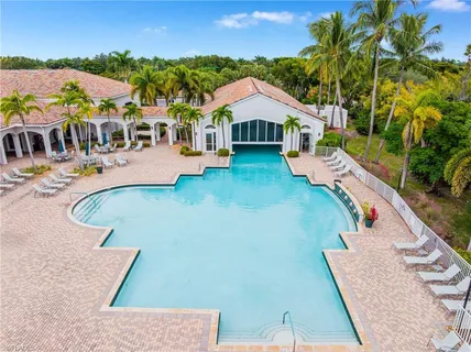 a view of house with swimming pool outdoor seating