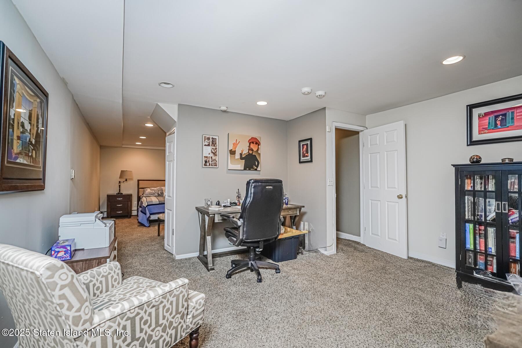 31 Savo Loop Staten Island, NY 10309 - Photo 28 of 41 a living room with furniture and a book shelf