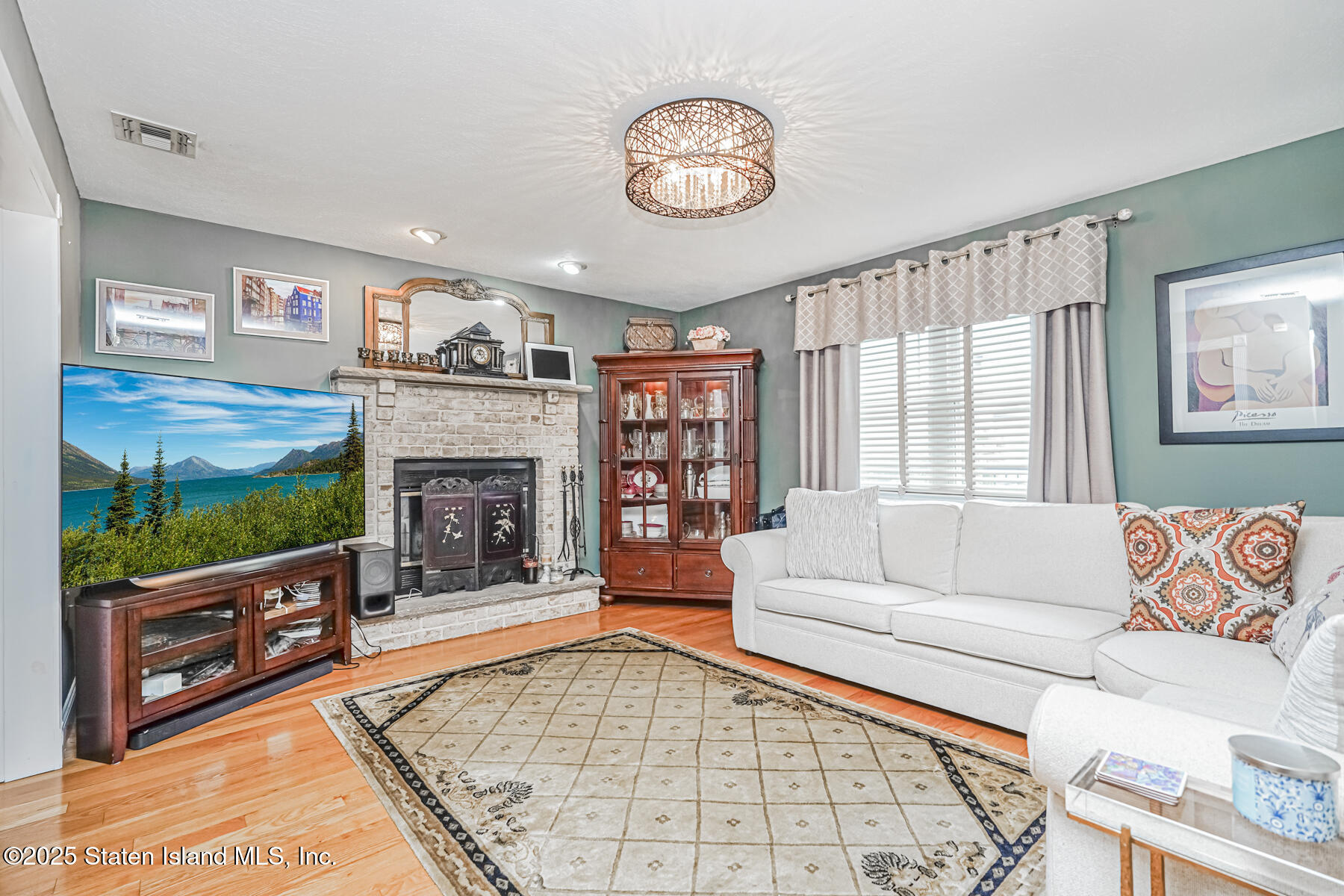 31 Savo Loop Staten Island, NY 10309 - Photo 9 of 41 a living room with fireplace furniture and a flat screen tv