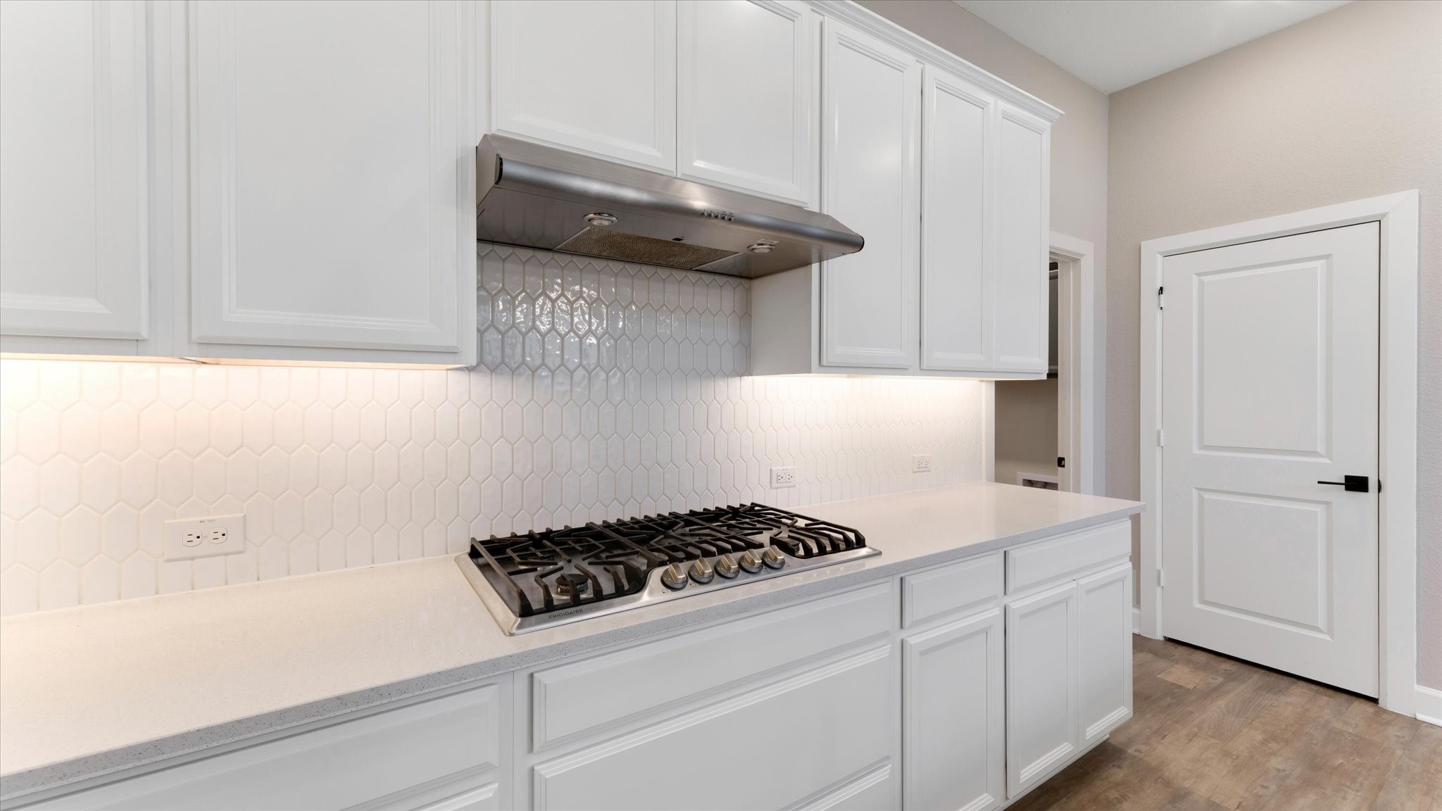 15607 Rising Wren Court Conroe, TX 77302 - Photo 13 of 40 a kitchen with a stove and cabinets