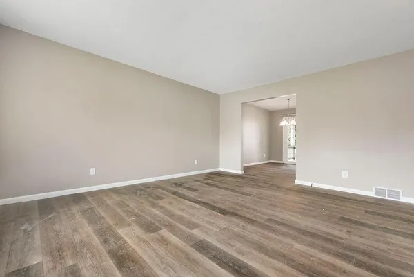 a view of an empty room and wooden floor